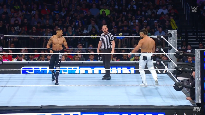 Hayes and Andrade staring one another down in the ring