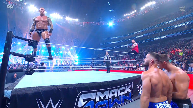 Orton and Owens in the ring as A-Town Down Under stares them down from the outside