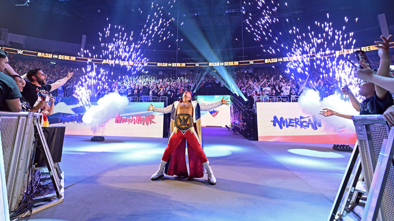 Cody Rhodes posing while fireworks go off