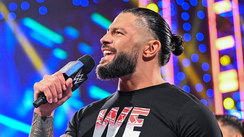 Roman Reigns speaking into a WWE microphone