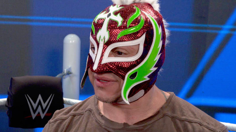 Rey Mysterio talking backstage at a WWE event