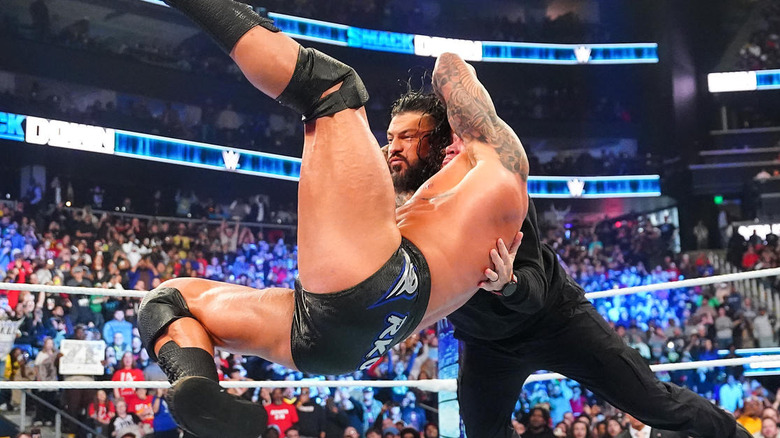 Randy Orton delivering an RKO to Roman Reigns