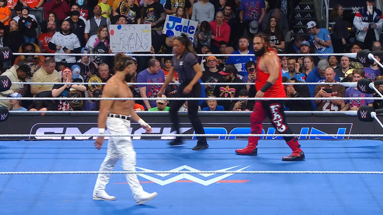 Andrade and Fatu staring each other down in the ring