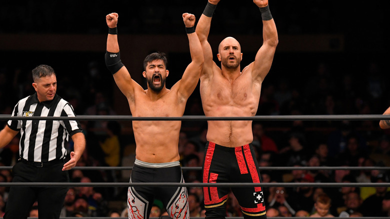 Claudio Castagnoli and Wheeler Yuta raise their arms in victory