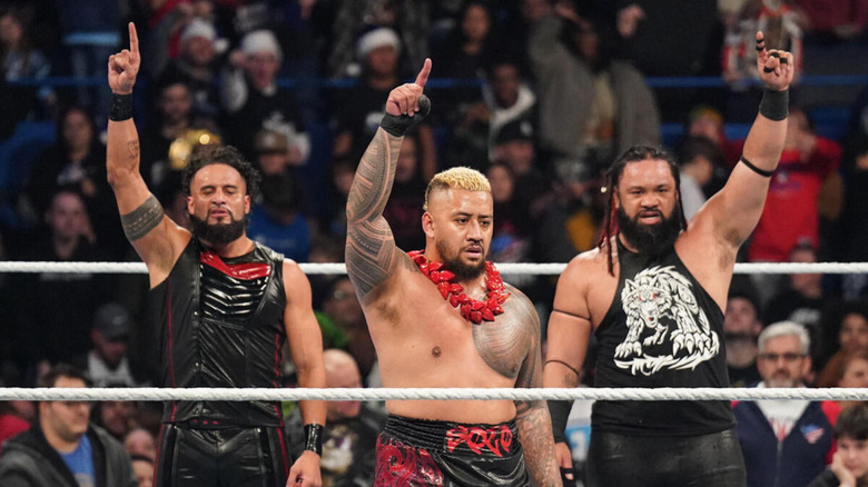 Tama Tonga, Solo Sikoa, and Jacob Fatu point their fingers to the sky