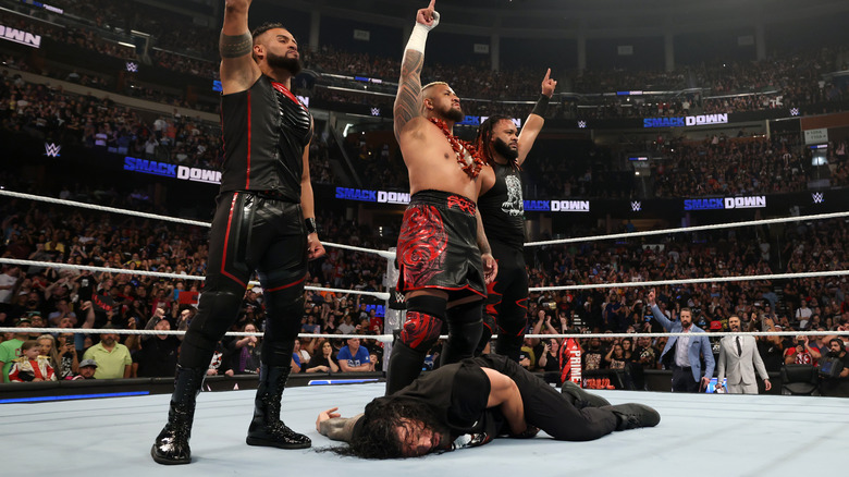 The Bloodline stands over Roman Reigns