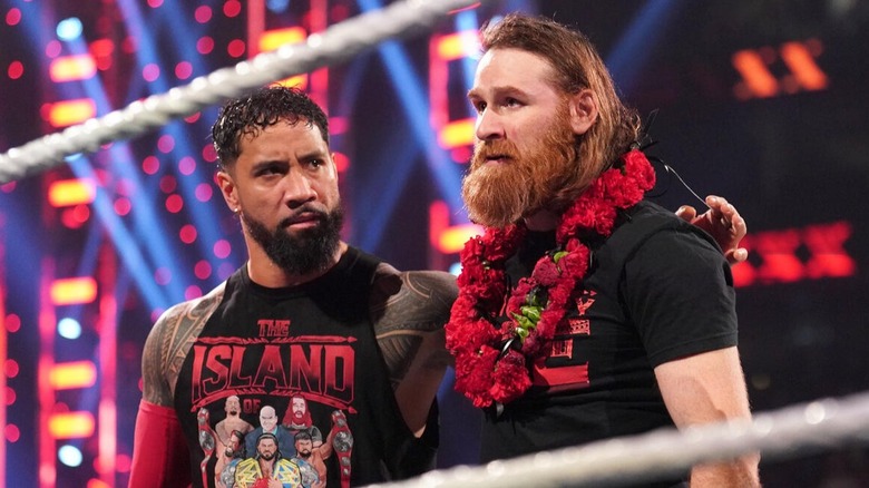 Jey Uso watches on as Sami Zayn ponders