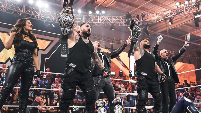 Akam and Rezar stand alongside The Final Testament, NXT Tag Team titles in hand.