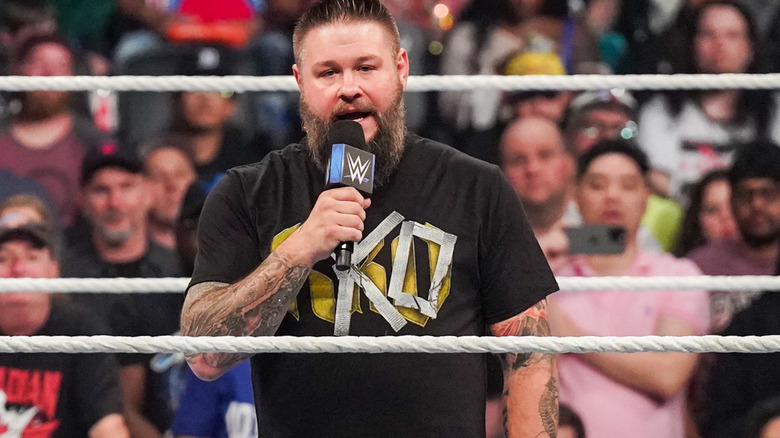 Kevin Owens talking into a microphne