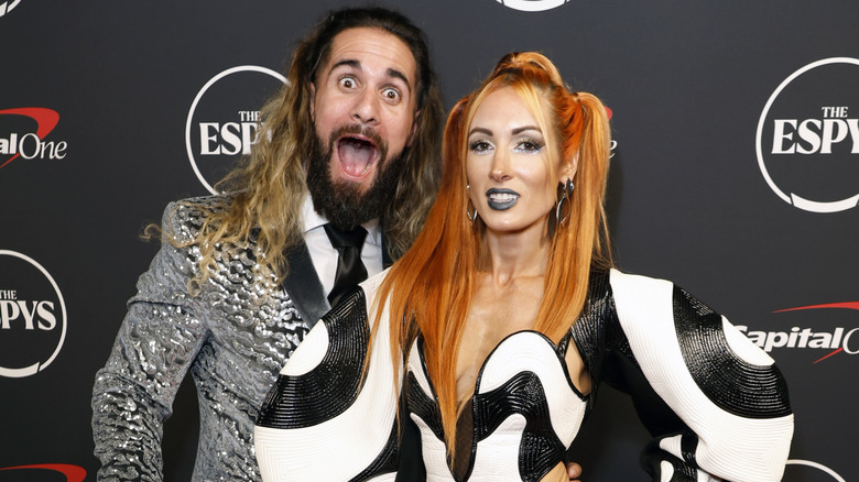 Seth Rollins making a funny face next to Becky Lynch