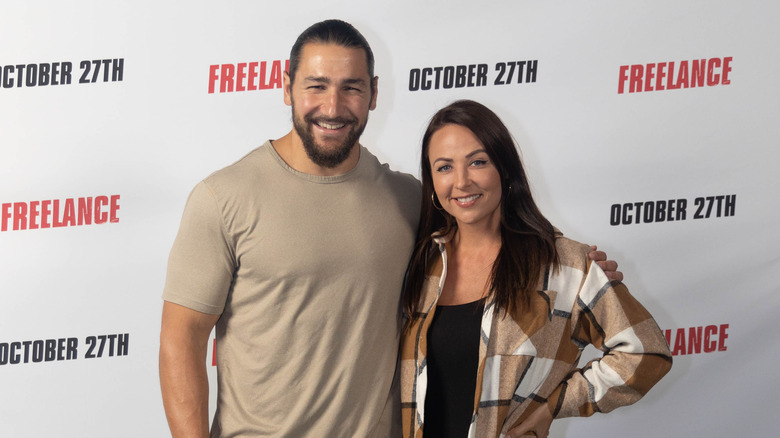 Tenille Dashwood and Riddick Moss pose for the camera at a movie premiere