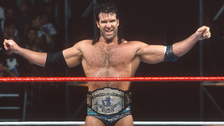 Scott Hall wearing intercontinental title belt, posing with arms outstretched