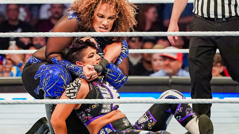 Nia Jax grappling with Bayley