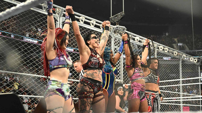 IYO SKY, Rhea Ripley, Naomi, Bianca Belair, and Bayley celebrate after winning women's WarGames at WWE Survivor Series