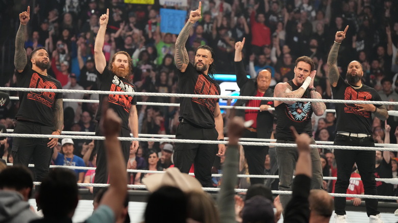 The Original Bloodline (plus CM Punk) raise the ones in the ring (or do their own pose) on "WWE SmackDown."