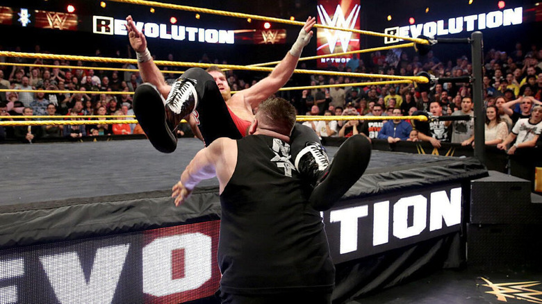 Kevin Owens powerbombs Sami Zayn on the ring apron at the end of NXT Takeover: R Evolution.