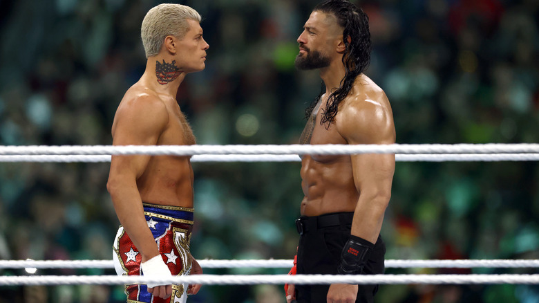 Cody Rhodes facing off with Roman Reigns