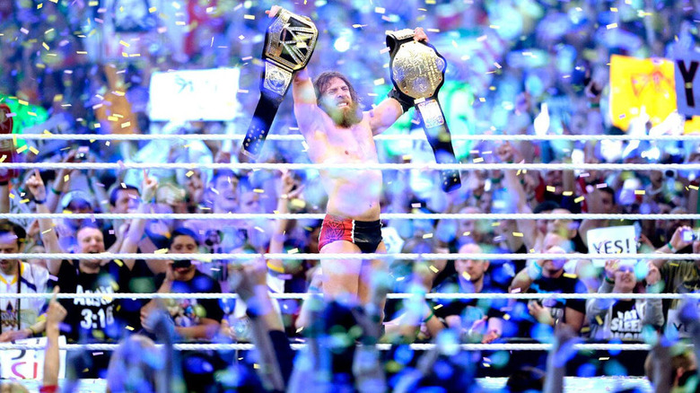 Daniel Bryan raises his world titles as confetti rains down