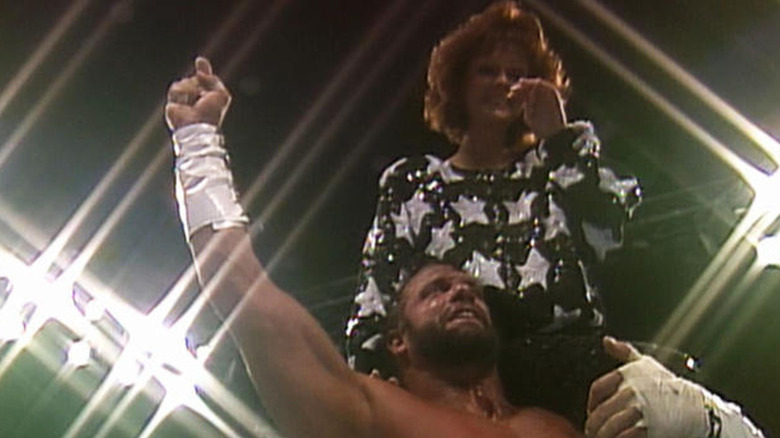 Randy Savage carrying Elizabeth on his shoulder