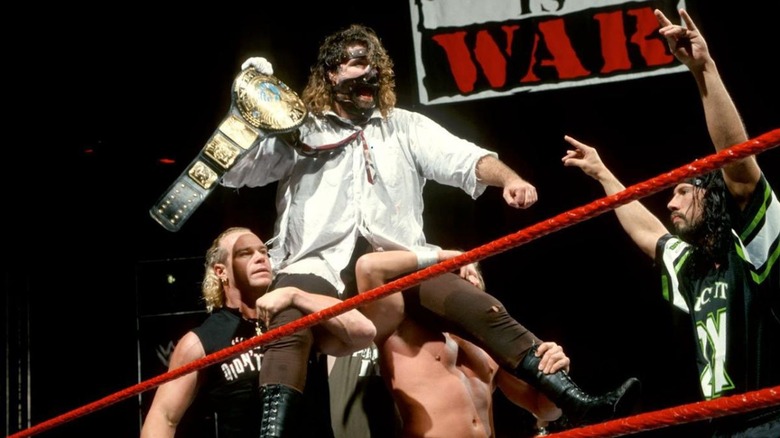 DX holding up a victorious Mankind