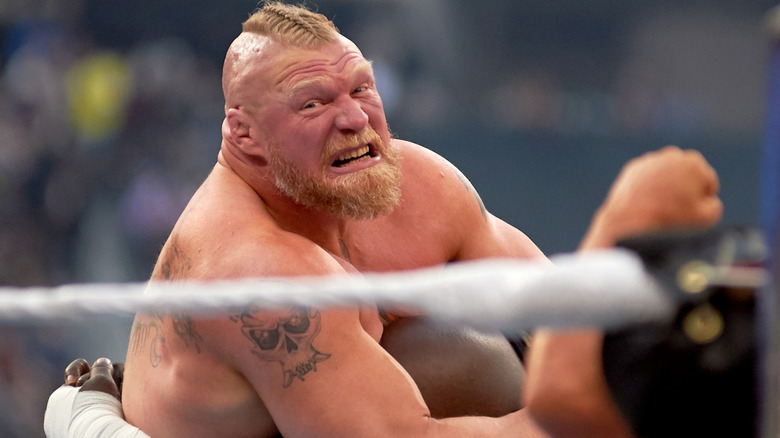 Brock Lesnar applies a submission hold to Omos at WWE WrestleMania 39