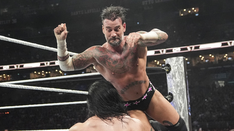 CM Punk hits Drew McIntyre with a flying clothesline outside the ring during SummerSlam at Cleveland Browns Stadium on August 3, 2024 in Cleveland, Ohio.