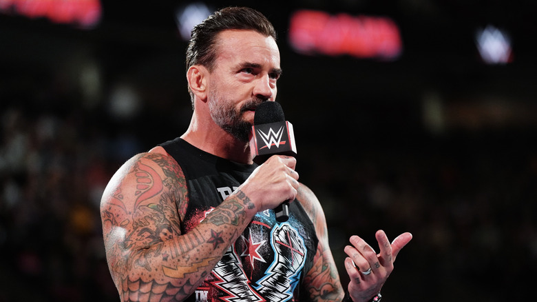 CM Punk speaking into a microphone