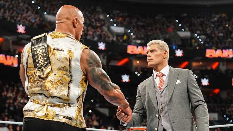 The Rock shakes hands with Cody Rhodes