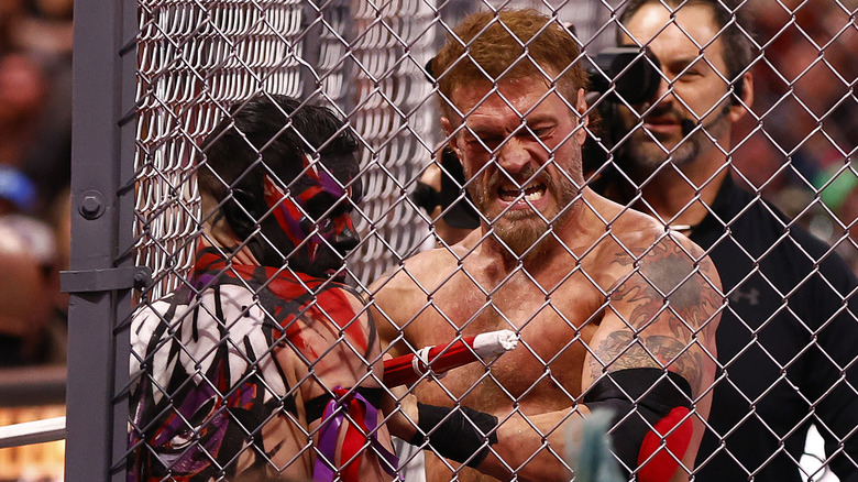 Finn Balor and Edge, Adam Copeland, in the cage