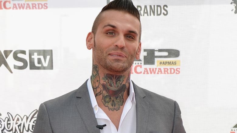 Corey Graves wearing a gray suit