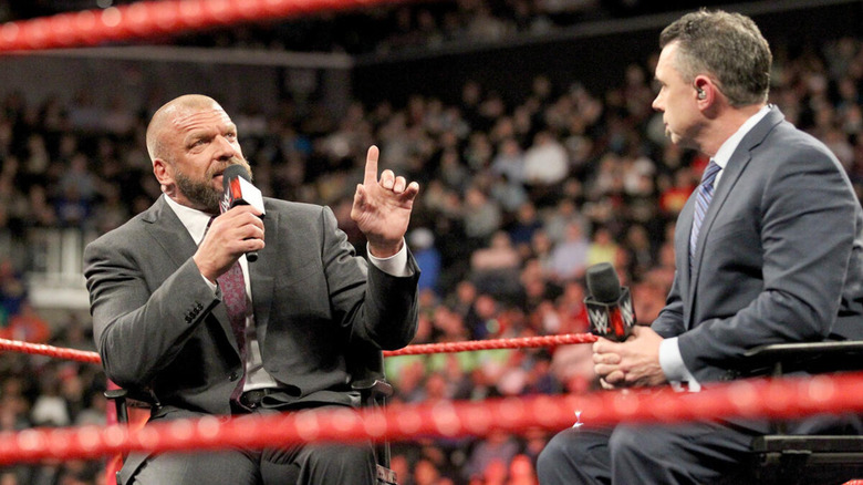 Triple H and Michael Cole in the ring