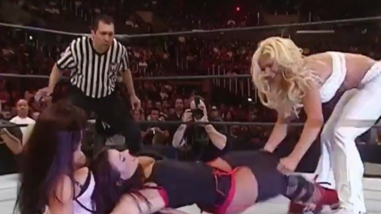 Torrie Wilson pulling off Candice Michelle's pants