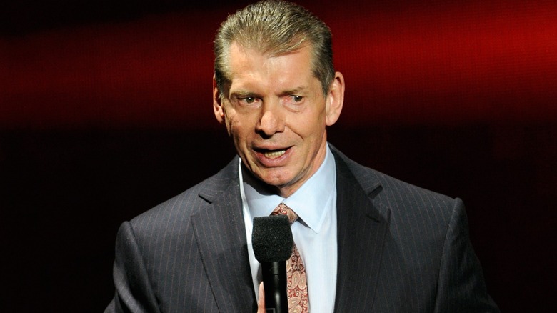 Vince McMahon talking into a microphone