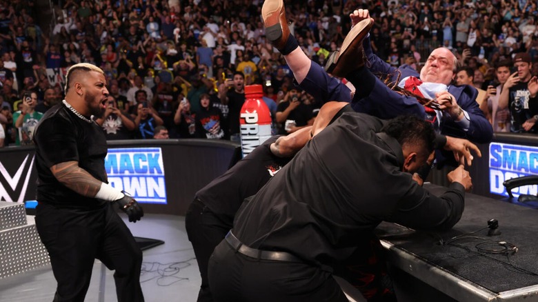 Paul Heyman being put through a table by Jacob Fatu, Tama Tonga and Tanga Loa