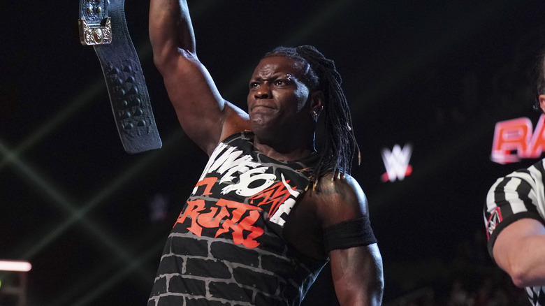 R-Truth holds his title belt high