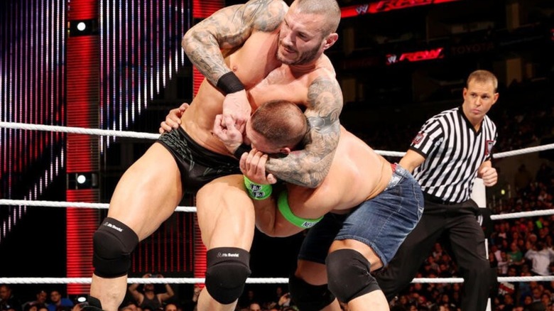 Randy Orton gets John Cena in a headlock