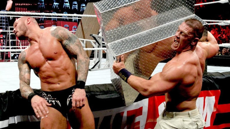 John Cena hits Randy Orton with the ring steps