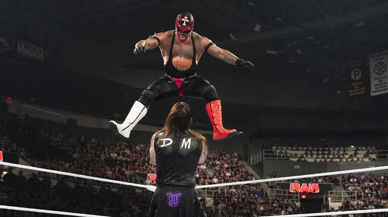 Rey Mysterio leaping at Dominik Mysterio