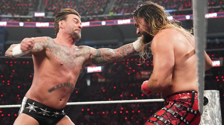 CM Punk clashing with Seth Rollins during the main event of the first 