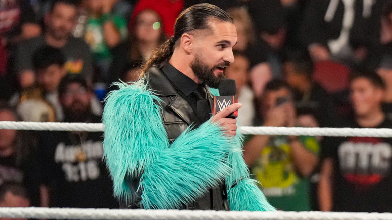 Seth Rollins wearing black with teel fur