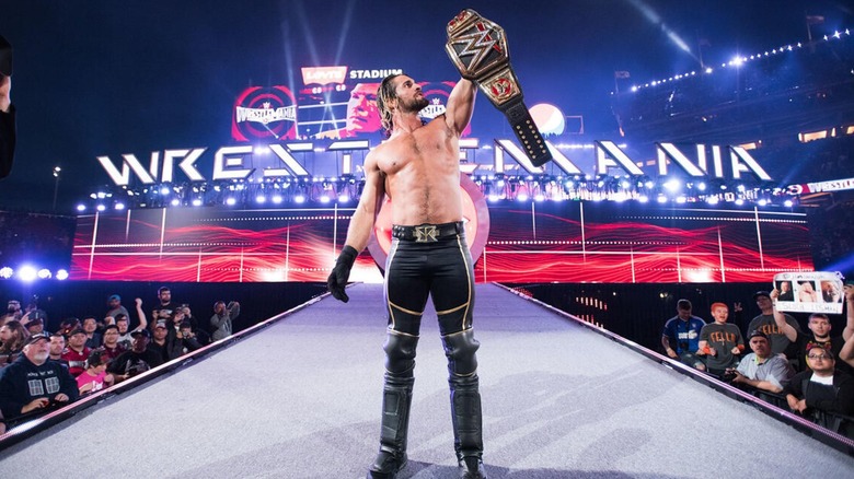 Seth Rollins holding the WWE World Heavyweight Championship at WrestleMania 31