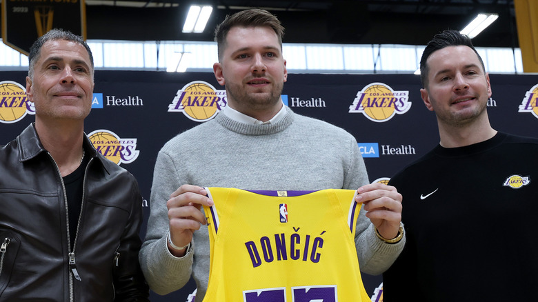 Luka Doncic holding up an LA Lakers jersey