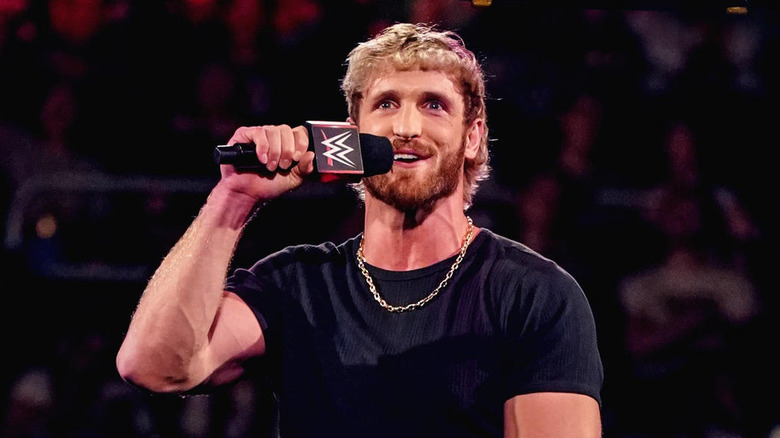 Logan Paul talking into a WWE microphone