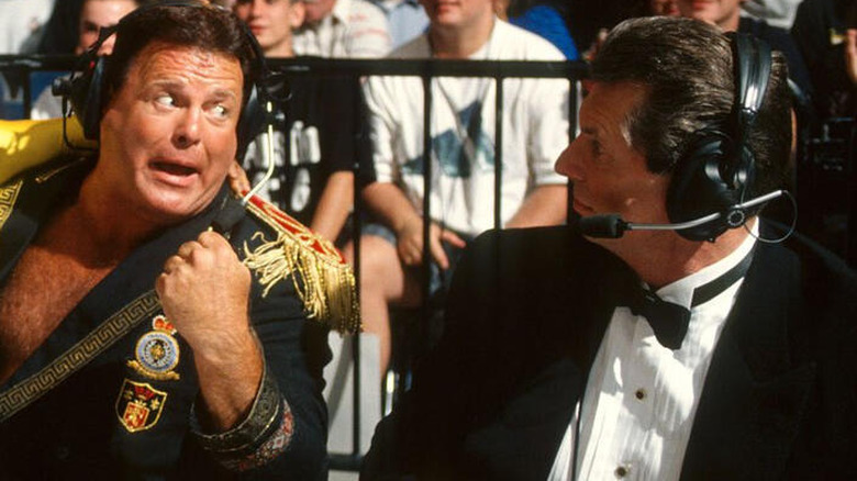 Jerry Lawler and Vince McMahon wearing headsets