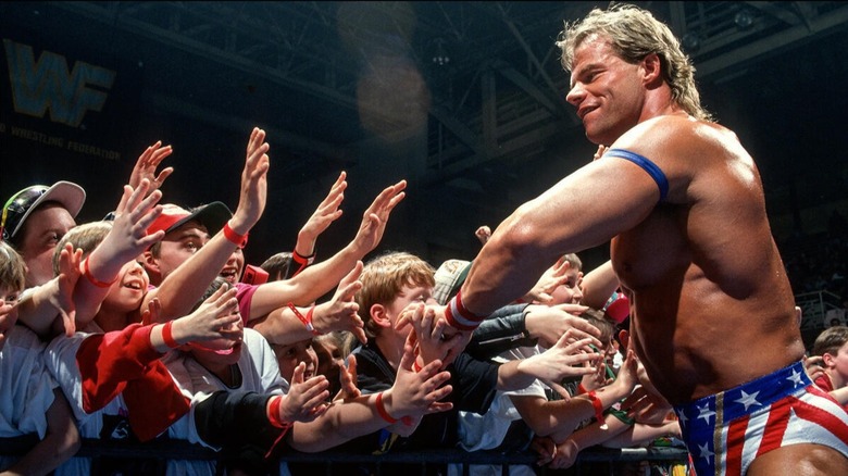 Lex Luger slaps the hands of younger fans who looked up to him during his tenured career